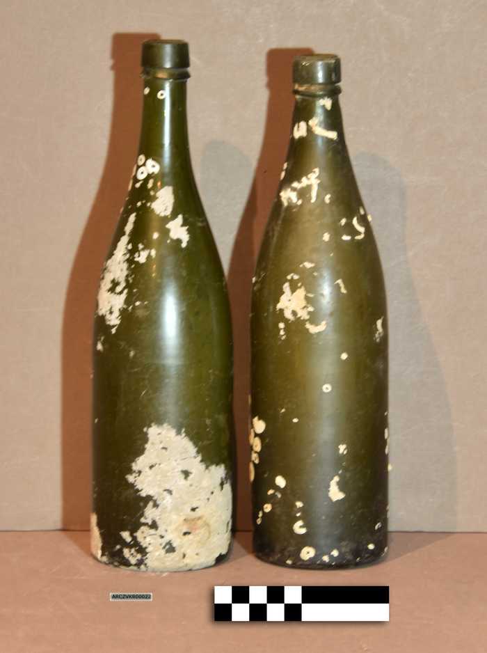 Twee groene flessen met zeepokken